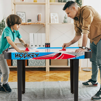 Father and son playing the game room air hockey table