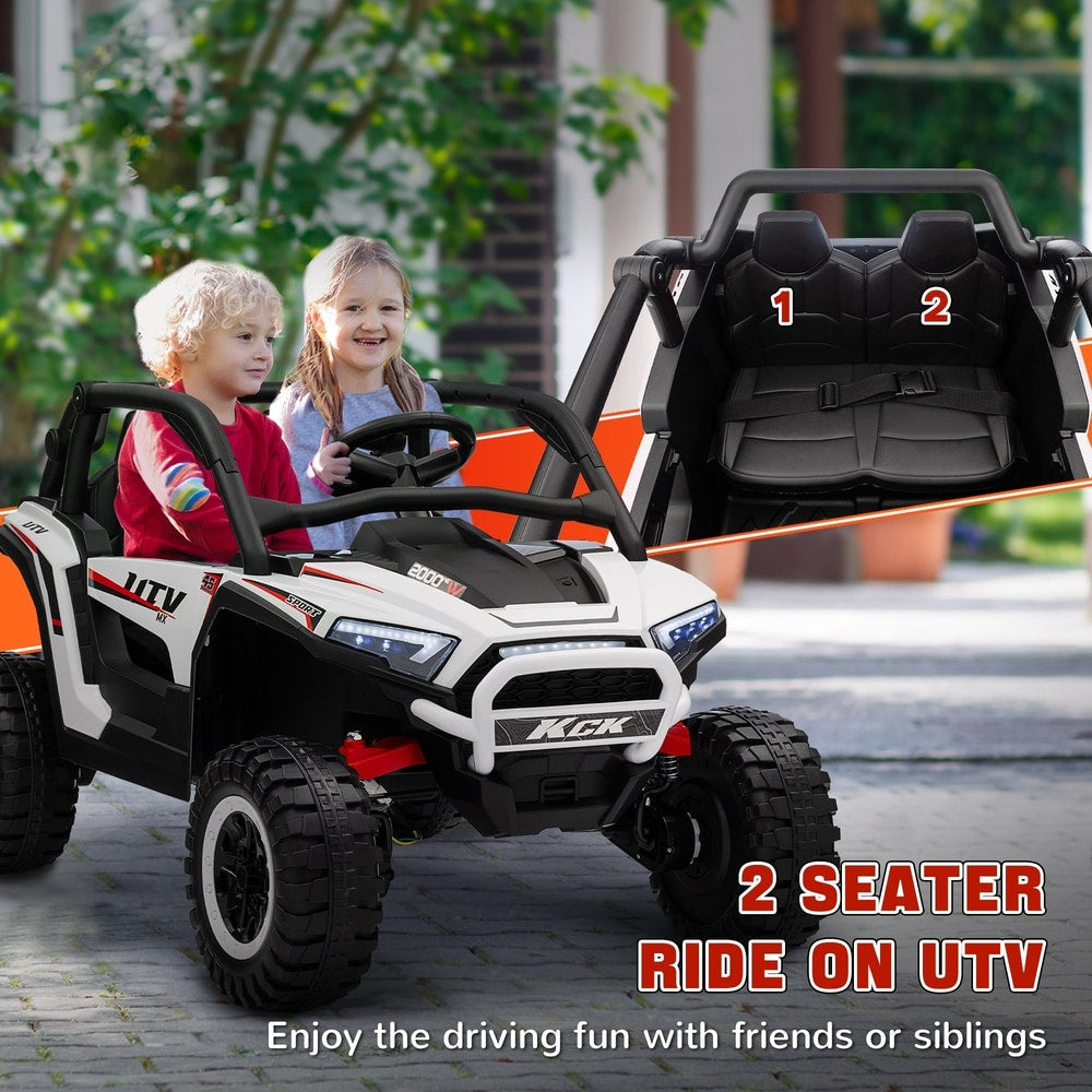 Two children sitting in the white two seater electric buggy, enjoying the ride