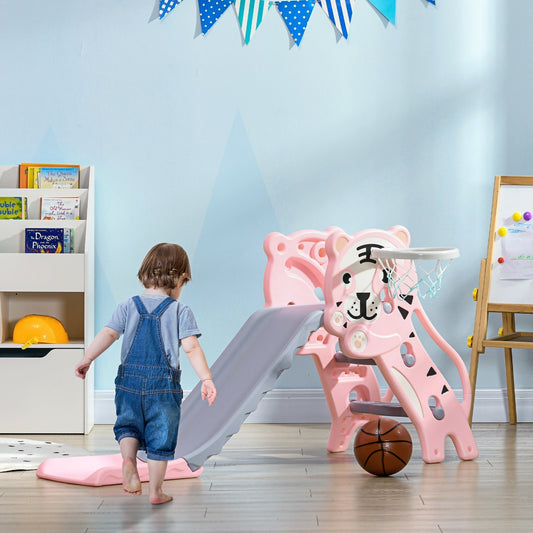The toddler slide set up in a playroom with a child standing next to it