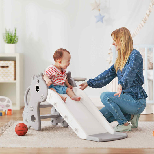A mother and baby playing on the grey giraffe toddler slide indoors