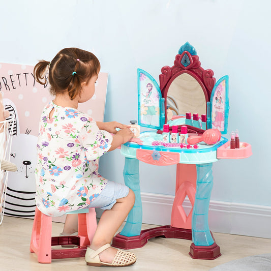 A young girl sits at the kids dressing playset, pretending to put on makeup