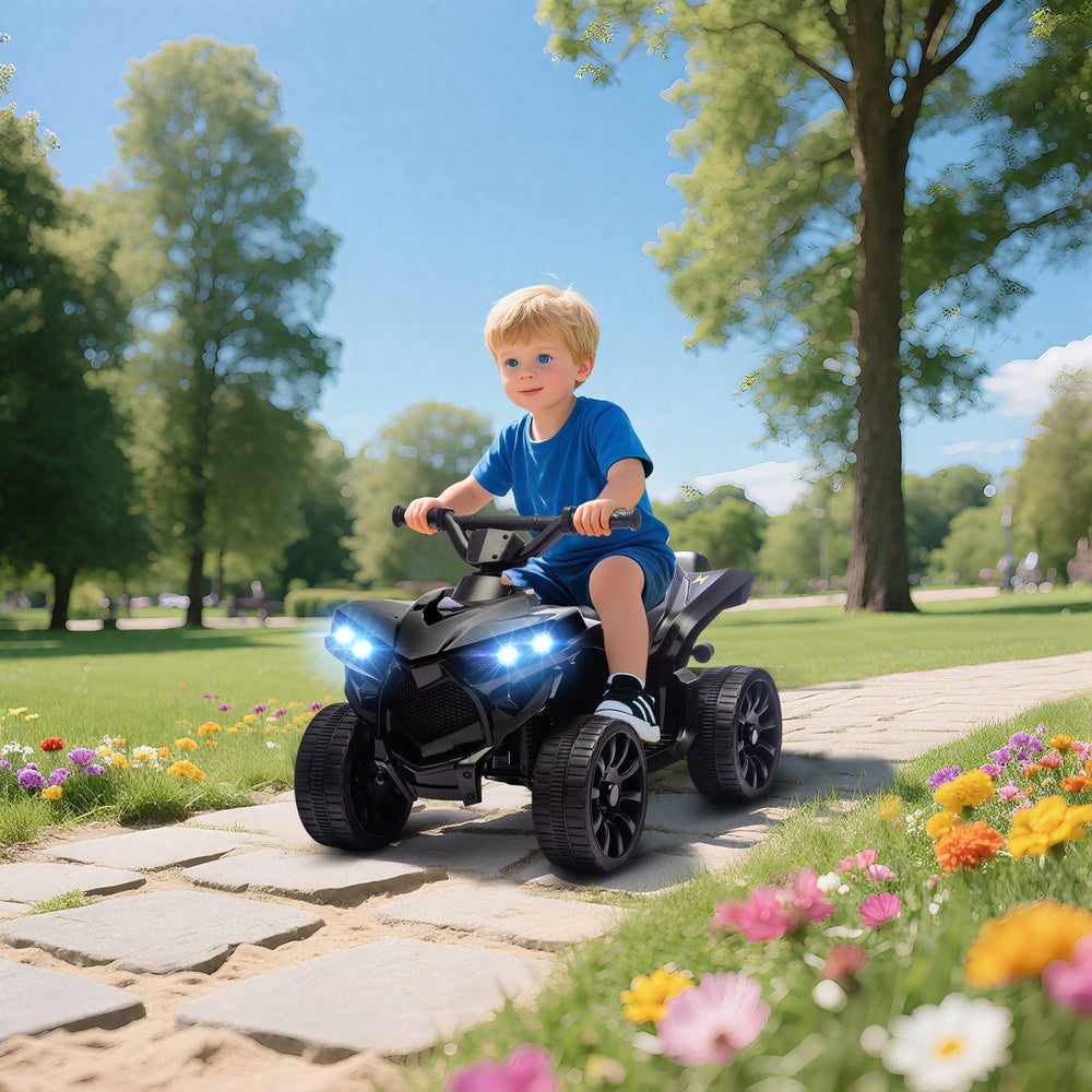 A young boy happily rides the black kids electric quad bike along a garden path