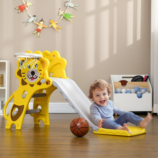 A happy toddler slides down the yellow lion-themed kids slide with basketball hoop in a room