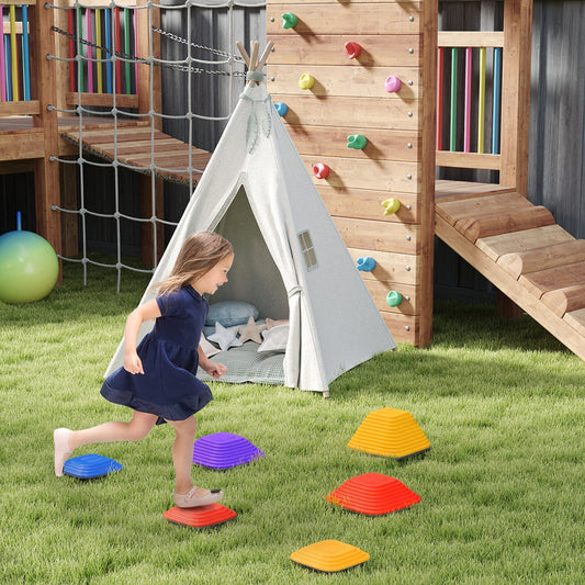 A young girl is playing on a garden obstacle course using the colourful stepping stones