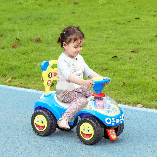 A young child happily riding the blue foot to floor toddler ride on toy in a garden