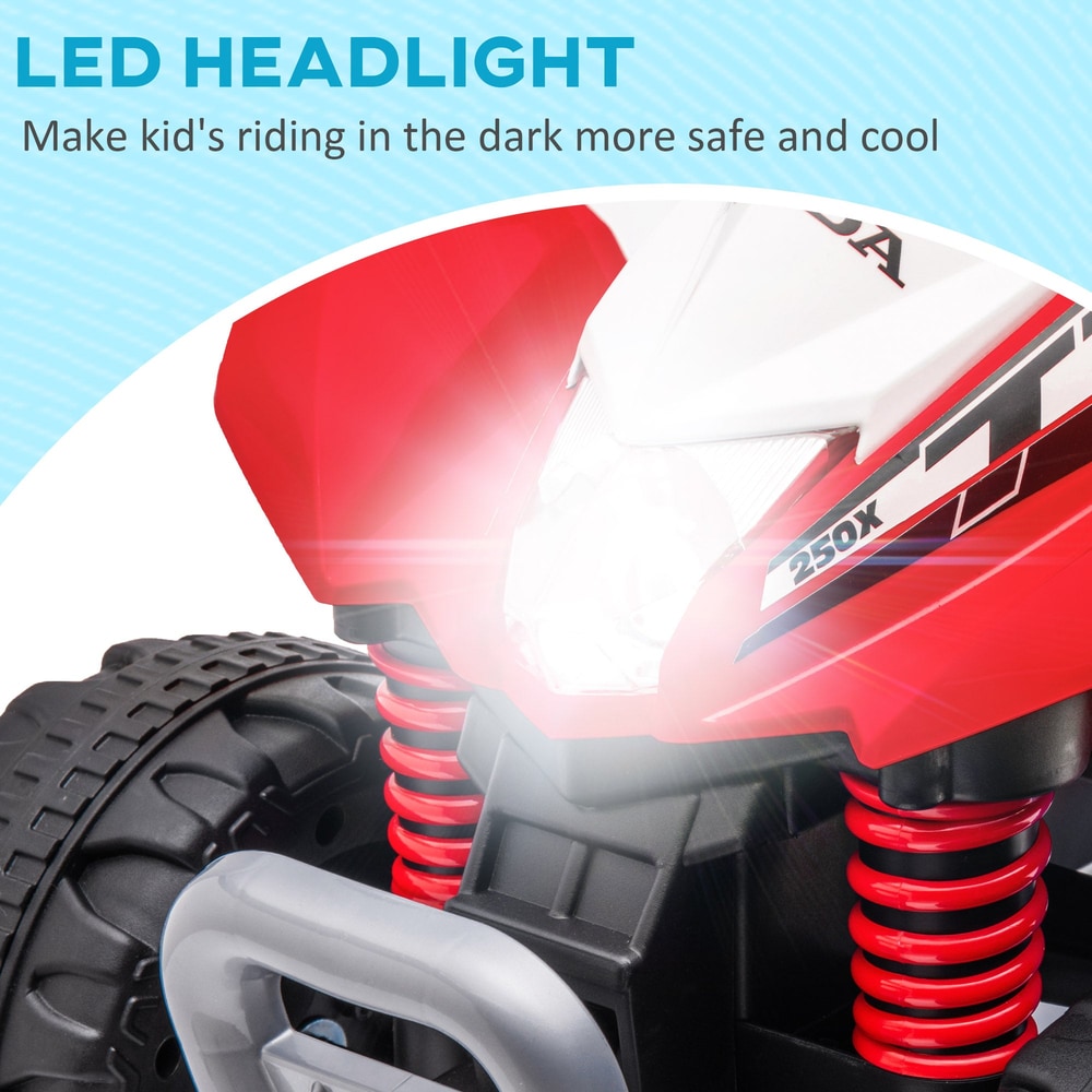 Close up of the front of the electric quad bike showing the bright illuminated headlight