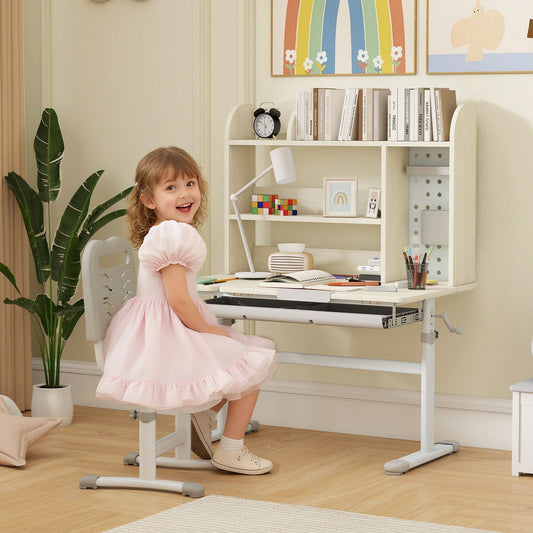 A young girl sitting at the wooden kids desk in a bright room with books and stationery