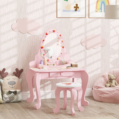 The pink strawberry-themed kids vanity table with stool set up in a child's bedroom