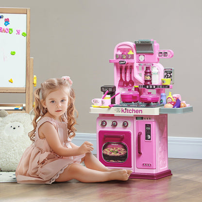 A young girl sitting on the floor playing with the pink role play toy kitchen set