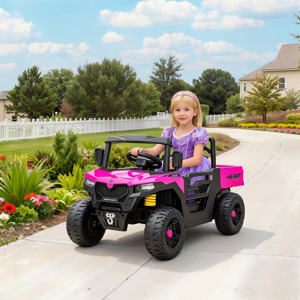 A young girl sitting in the pink kids electric UTV on a paved garden path