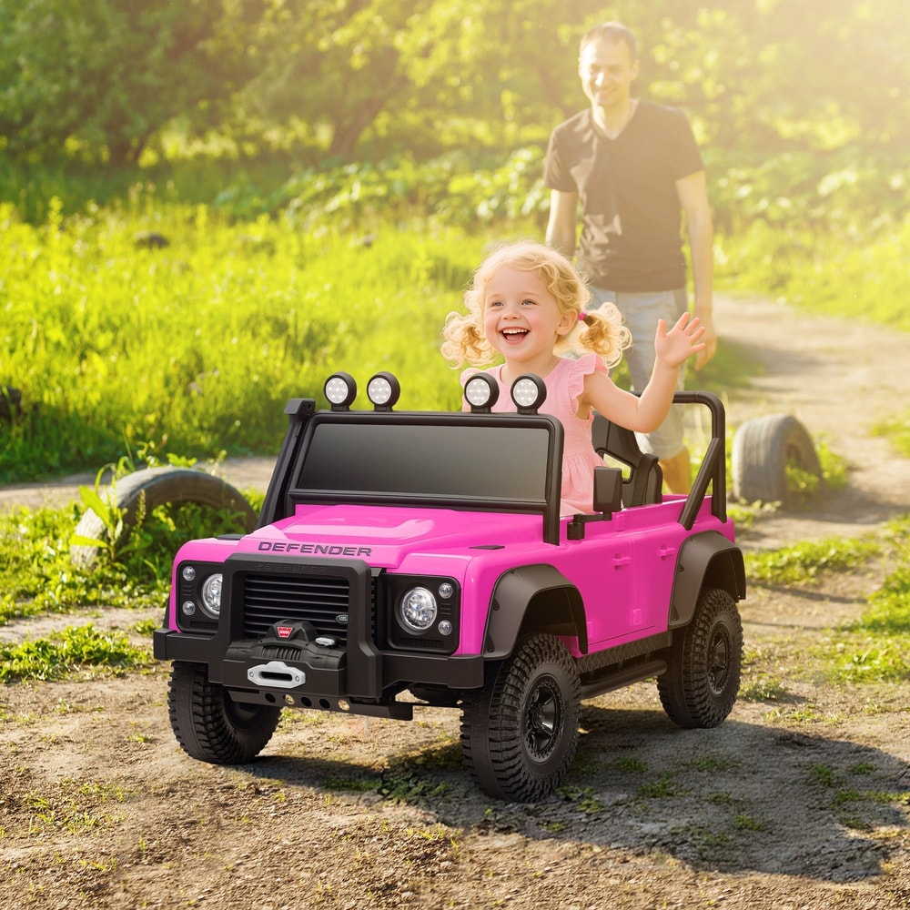 The pink kids electric car parked on a dirt path with four roof lights and a black front bumper