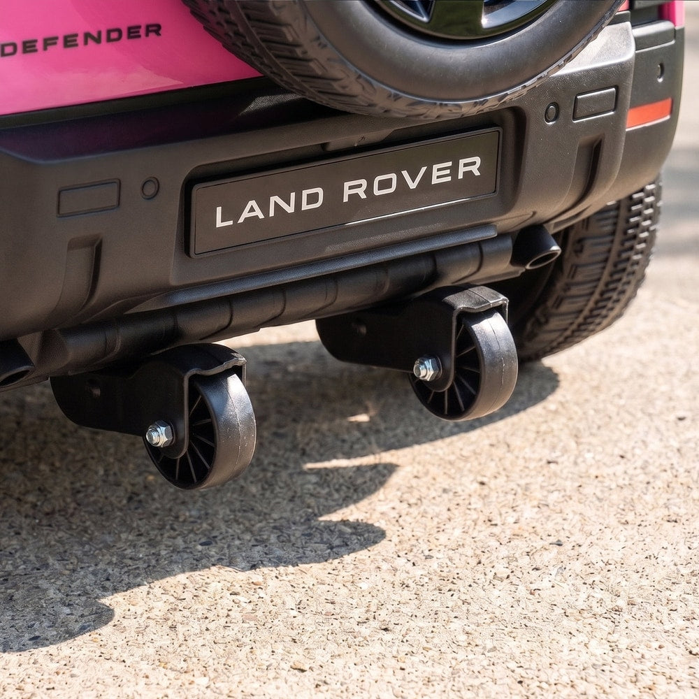 Close up of the small transport wheels underneath the pink kids ride on car