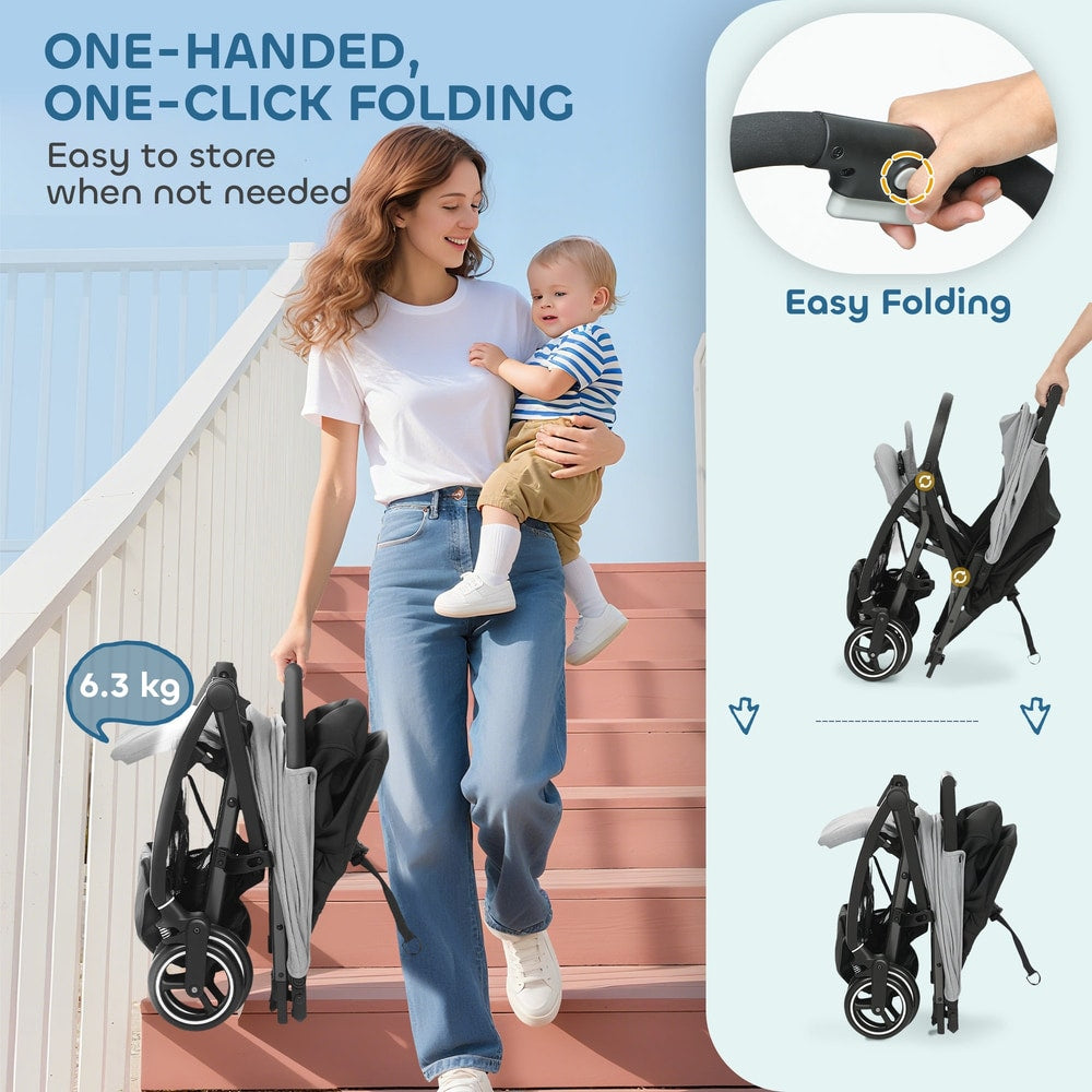A woman holding a baby and a folded light grey travel stroller