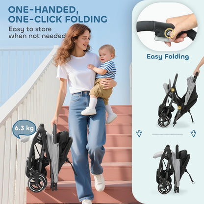 A woman holding a baby and a folded light grey travel stroller
