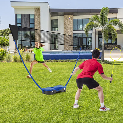 The portable badminton net set in use on a lawn with two children playing badminton