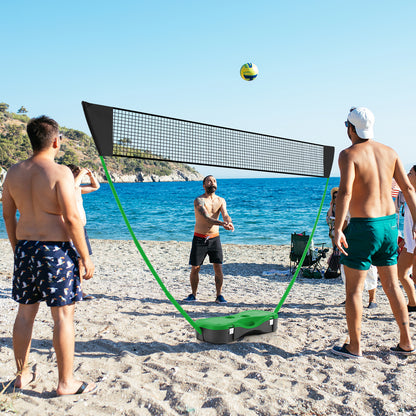 The badminton net set positioned on a sandy beach with a blue sea background