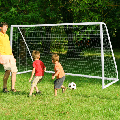 The white soccer goal frame and netting set up on a lawn with a man and two children nearby