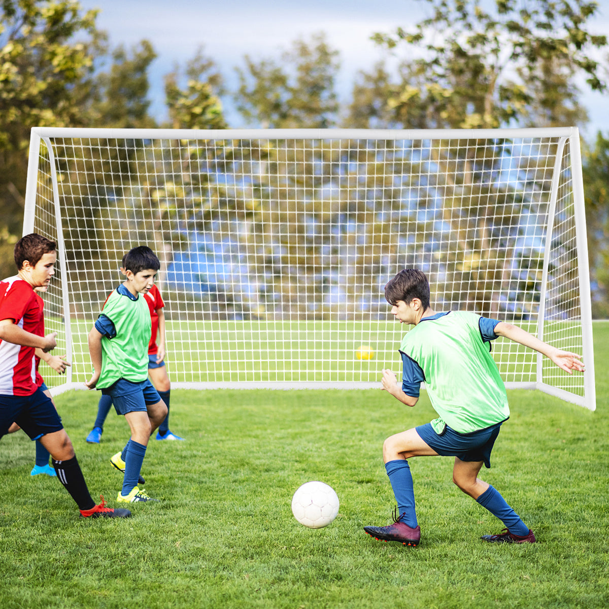 The white soccer goal frame and netting positioned on a green grass pitch during a match