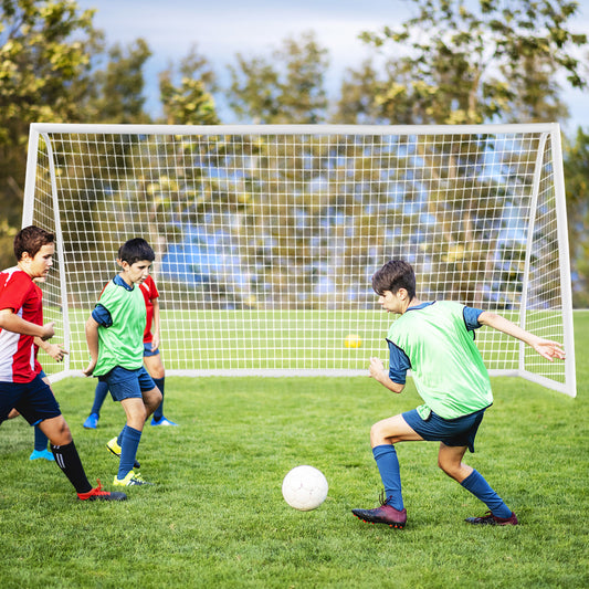 The white soccer goal frame and netting positioned on a green grass pitch during a match