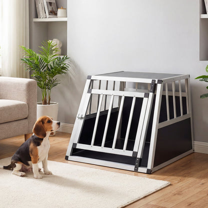Aluminium dog transport box with a beagle dog sitting next to it in a living room