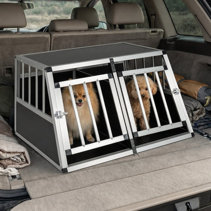 The dog transport box inside a vehicle with two small dogs sitting inside the compartments