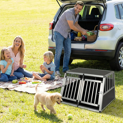 The dog transport box sitting on grass near a family having a picnic by their car