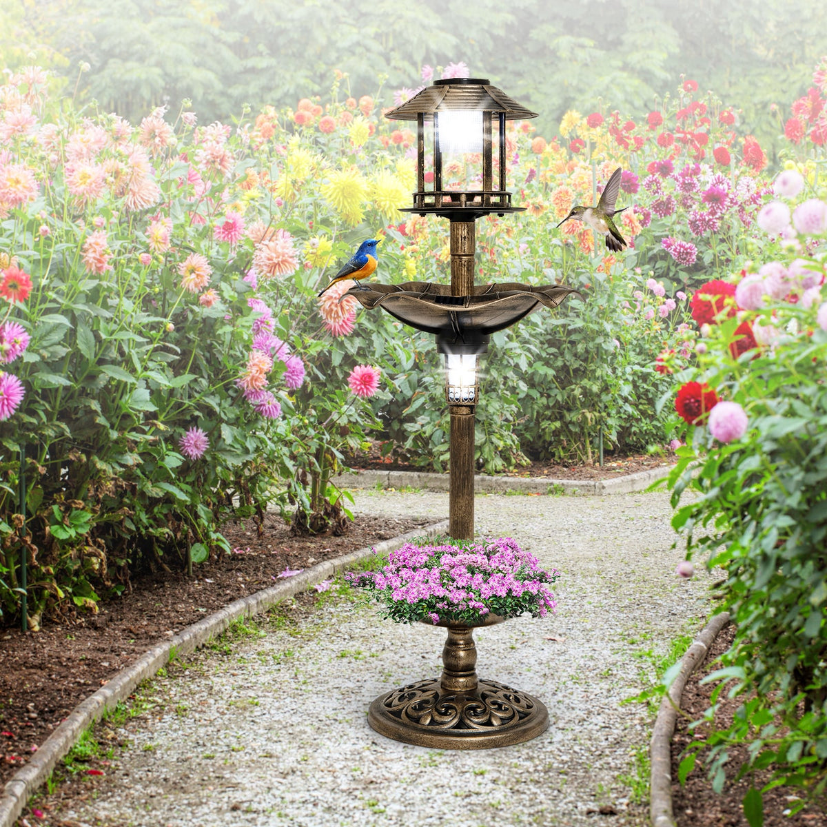 The antique birdbath and feeder combo is shown in a garden setting with flowers and a path