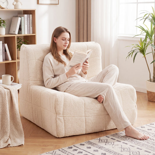 The floor sofa placed in a bright living room with a woman sitting and reading a book