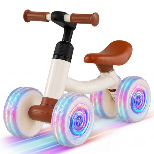 Baby Balance Bike with brown seat and handlebars and glowing wheels on a white background
