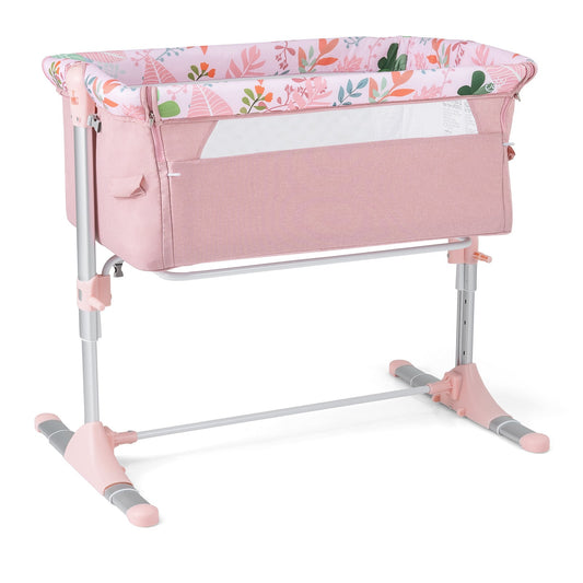 Baby Bassinet Crib Bedside Sleeper with Adjustable Height in pink with a floral pattern