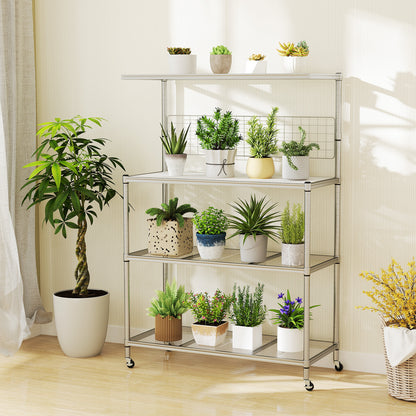 The bakers rack on wheels, styled as a plant stand with various potted plants on each shelf