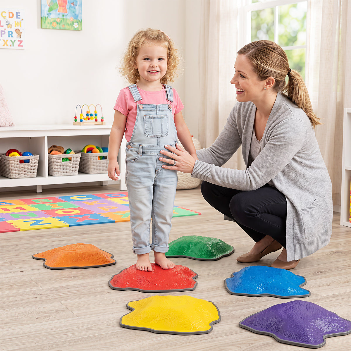 A woman and child using stepping stones in a playroom