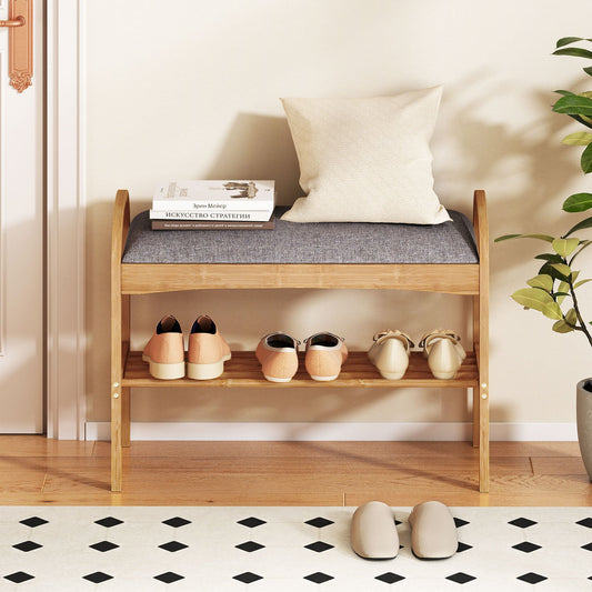 The shoe bench placed in a hallway with books and a cushion on the seat