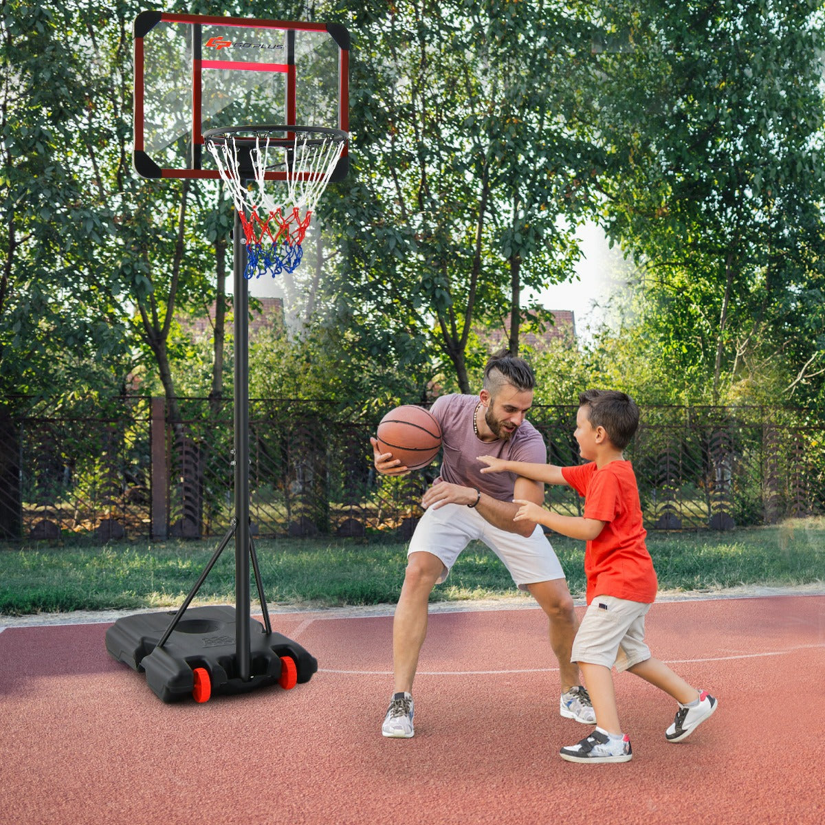 A father and son playing basketball with the hoop and goal set outdoors