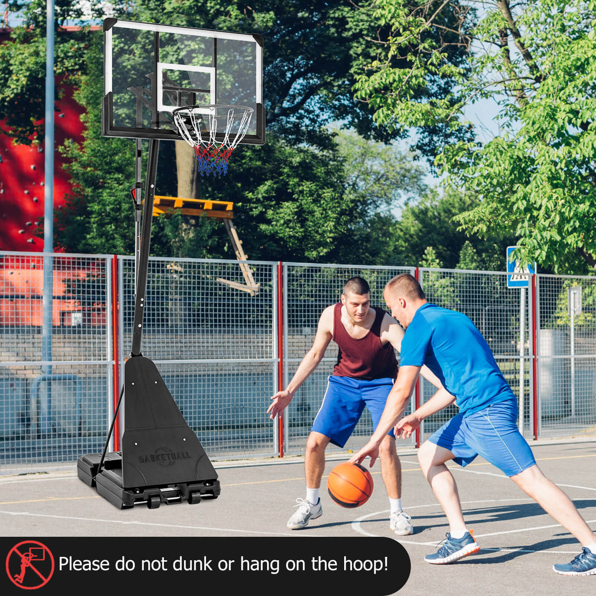 Two men playing basketball with the portable hoop system on an outdoor court