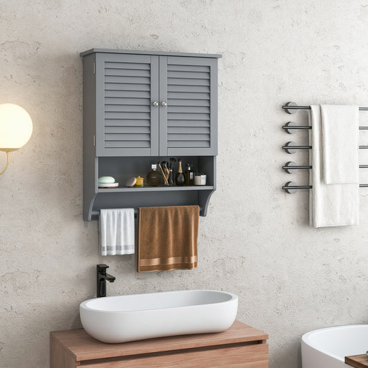 The grey wall cabinet is shown installed above a sink with toiletries and towels