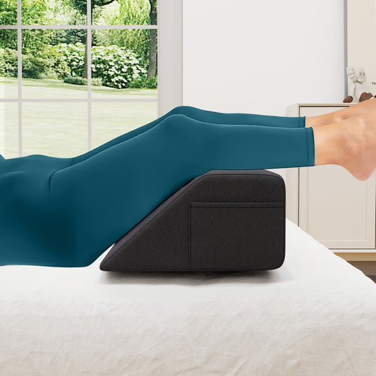 The bed wedge pillow used to elevate legs while lying on a bed