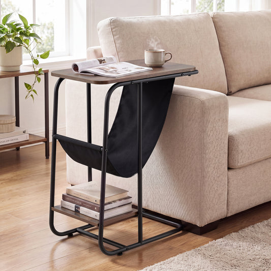 The end table placed next to a beige sofa with a magazine and a cup of coffee on top