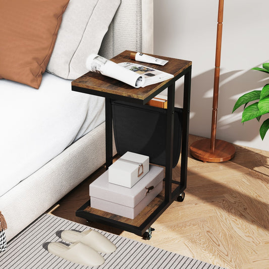 The end table next to a bed with books and a coffee cup on top