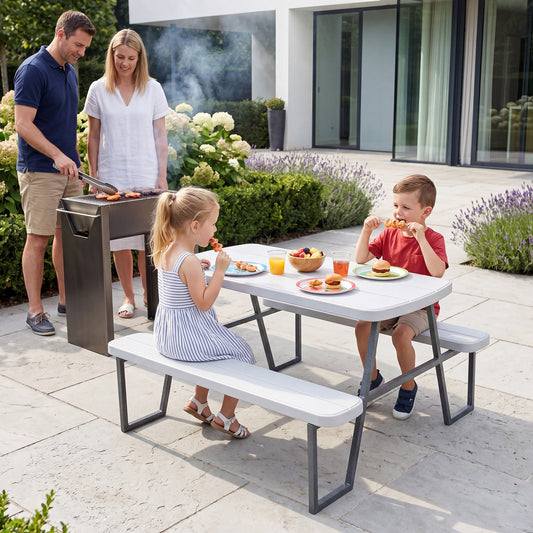 Family enjoying a barbecue at the white picnic table and chairs set outdoors