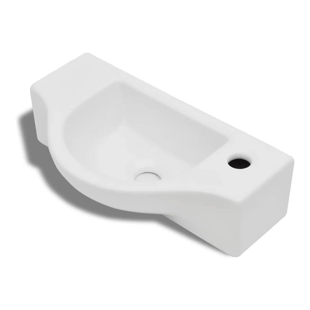 White ceramic bathroom basin with a single faucet hole and a small overflow hole