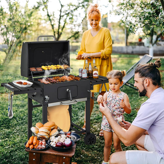 The outdoor grill being used by a family in a garden setting with food being prepared