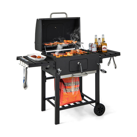 Charcoal BBQ Grill with food cooking on the grates and bottles on the side table