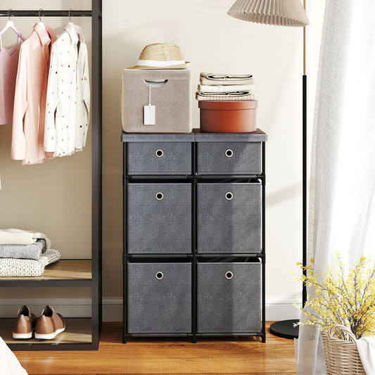 The chest of drawers in a bedroom setting next to a clothes rack and a floor lamp