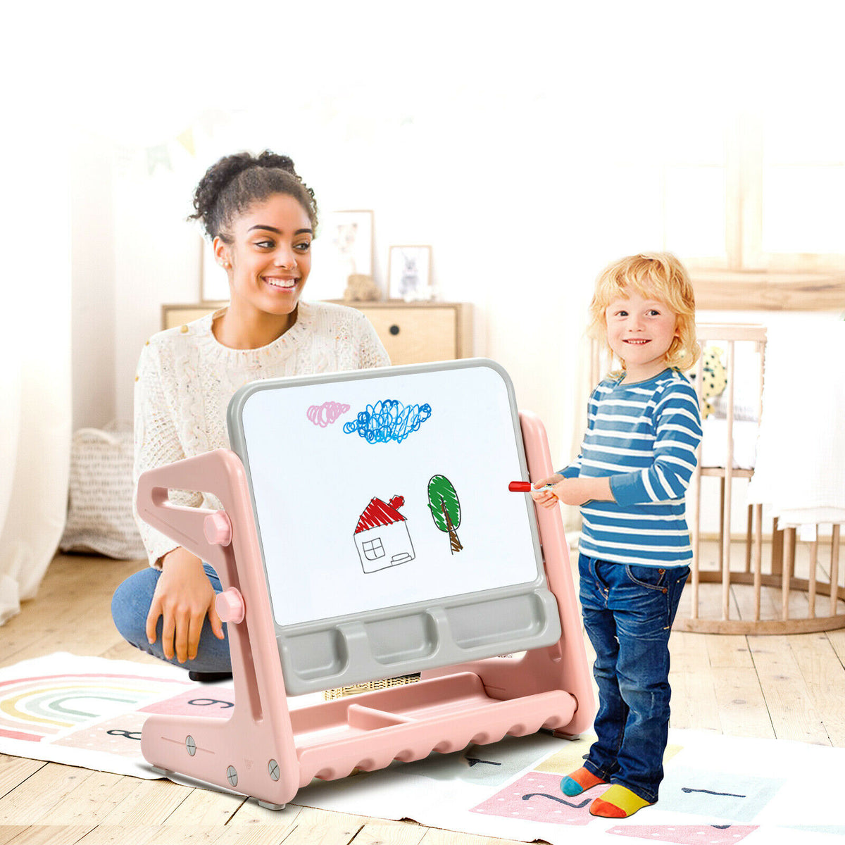 A woman and child using the art easel and chair set together