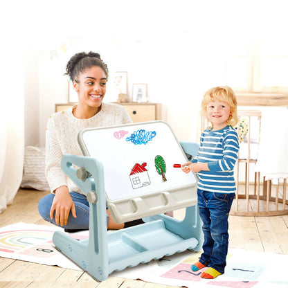The art easel being used by a child drawing while an adult watches nearby