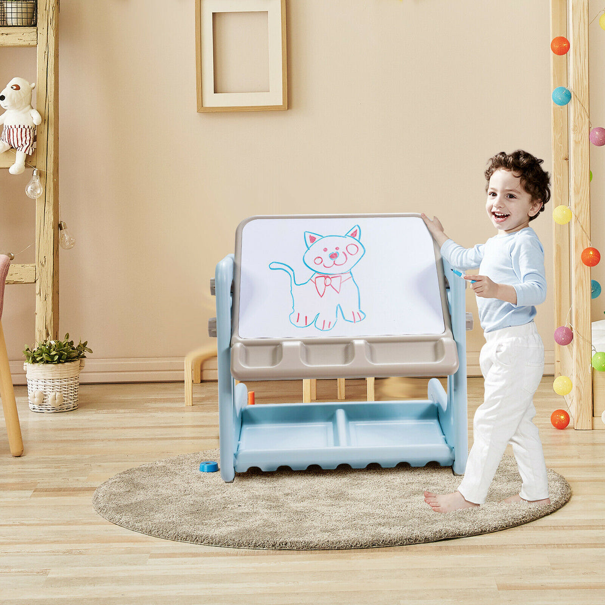 The art easel standing on a rug with a child drawing a cat on the whiteboard