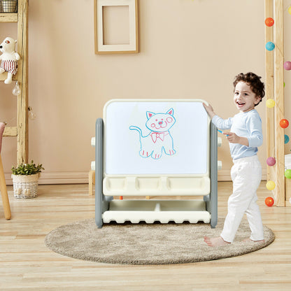 A young boy stands by the art easel table and chair set