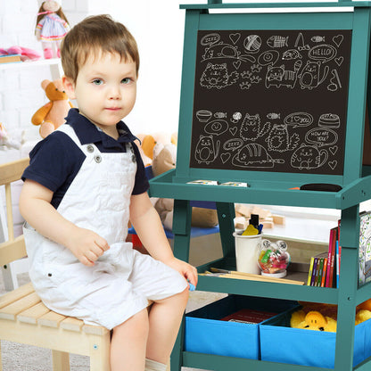 A young boy sitting on a stool next to the blue children's art easel