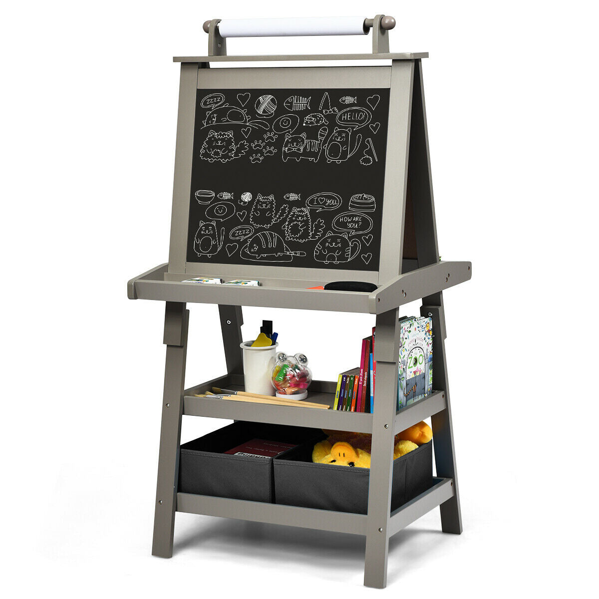 The art easel showing the blackboard side with drawings and storage underneath
